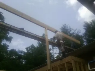 Carpenter setting a ridge beam over a new addition frame — Ice Dam Removal by Roofing Brothers in Palos Verdes Peninsula
